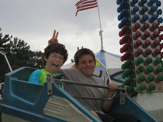 My son and his best friend Michael at the fair.  They got their hands stamped in one of those "all you can ride" deals 'til 3pm and they just went nuts.  They had a great time, ate too much fair food, spent too much money on the fair games, a good typical day at the county fair.